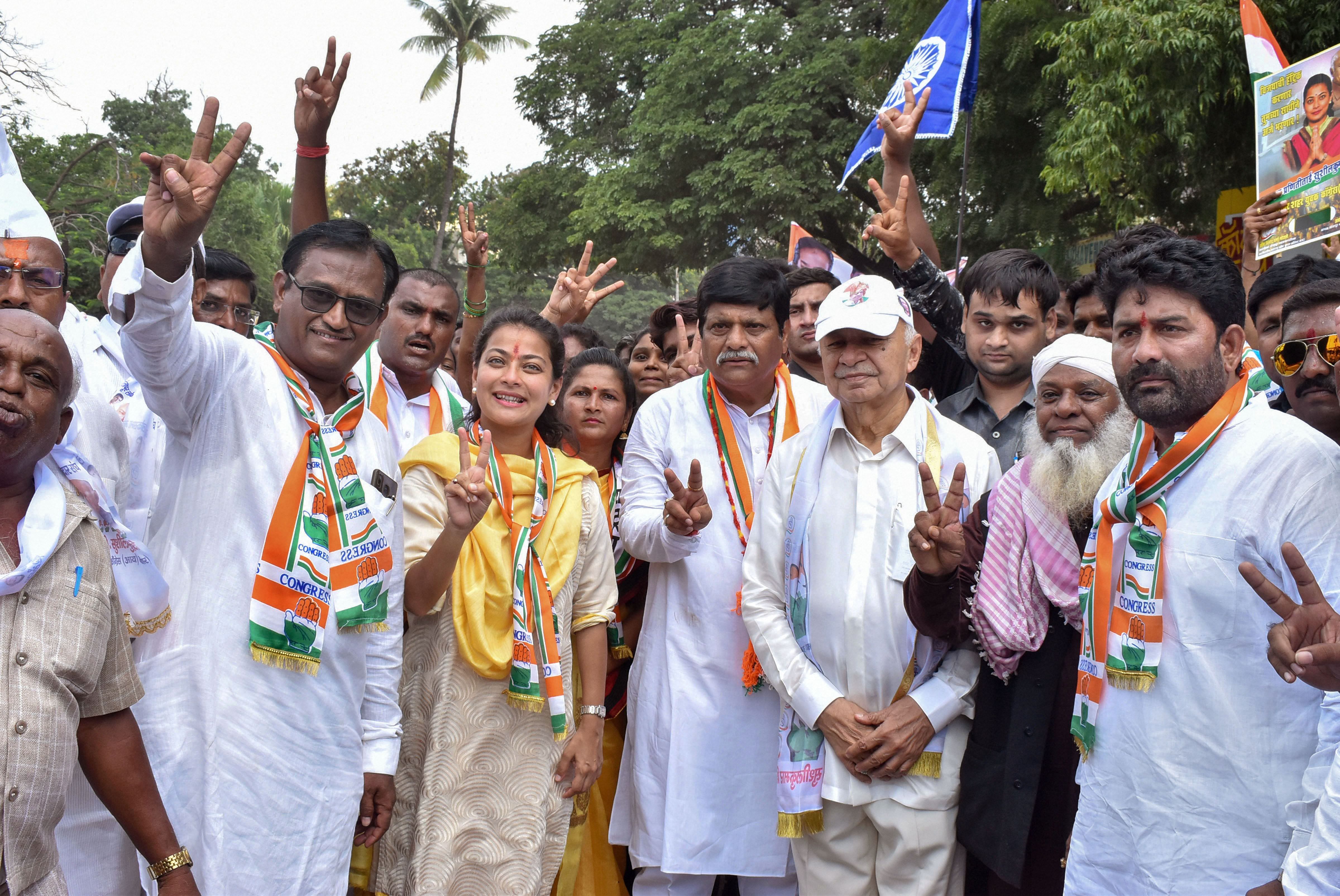 Congress candidate for Solapur seat Praniti Shinde with her father and former Union minister Sushilkumar Shinde and other leaders during her nomination filing procession, in Solapur, Maharashtra. (PTI Photo)