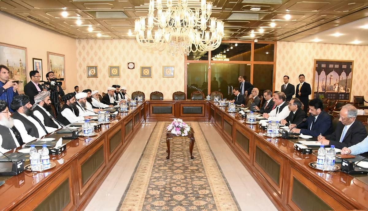 Pakistan's Foreign Minister Shah Mehmood Qureshi (4R) holds talk with Taliban co-founder Mullah Baradar (4L) and his delegation at the Pakistan Foreign Ministry in Islamabad. (Pakistan Foreign Ministry / AFP)