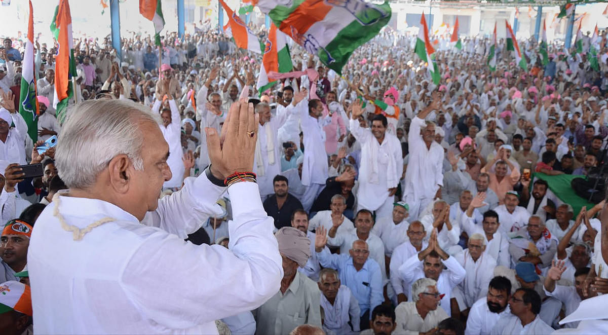 Former Haryana Chief Minister and senior Congress leader Bhupinder Singh Hooda greets his supporters during a rally before filing his nomination papers for the forthcoming Assembly polls, in Rohtak, Friday, Oct. 4, 2019. (PTI Photo)