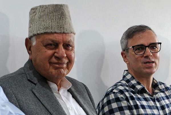 National Conference (NC) leader Farooq Abdullah (C), former chief minister of Jammu and Kashmir, looks on after winning his Srinagar constituency parliament seat, next to his son Omar Abdullah (R), in Srinagar on May 23, 2019. (AFP Photo)