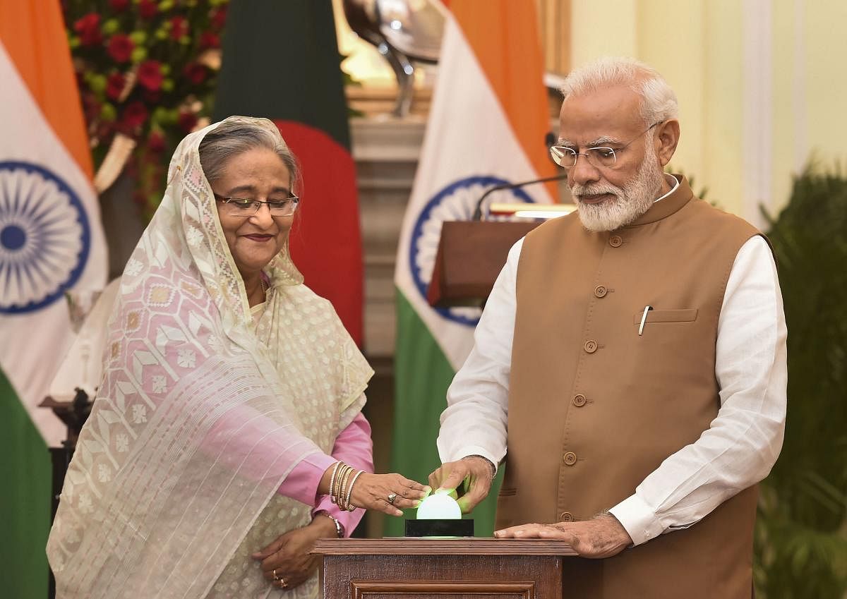 Prime Minister Narendra Modi with his Bangladeshi counterpart Sheikh Hasina launches a bilateral project after a meeting at Hyderabad House in New Delhi, Saturday, Oct. 5, 2019. (PTI Photo)