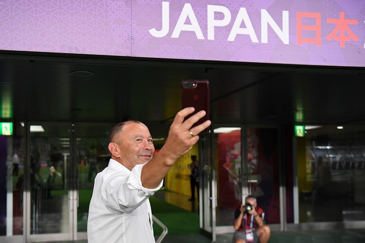 England's head coach Eddie Jones takes a selfie after victory during the Japan 2019 Rugby World Cup Pool C match between England and Argentina at the Tokyo Stadium in Tokyo on October 5, 2019. (AFP)