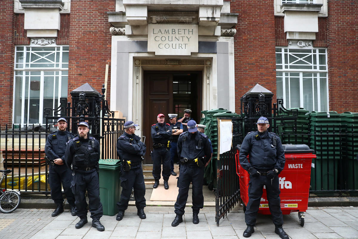 Police officers stand guard outside Lambeth County Court, during a raid on an Extinction Rebellion storage facility, in London, Britain October 5, 2019. Reuters