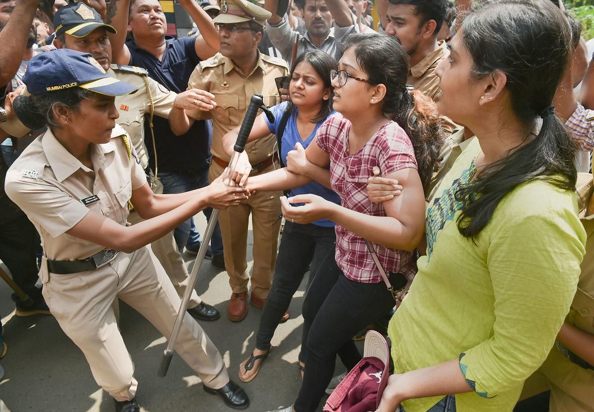 Police detain activists who were staging a protest against the tree-cutting, being carried out for the Metro car shed project, at Aarey colony in Mumbai. (PTI Photo)