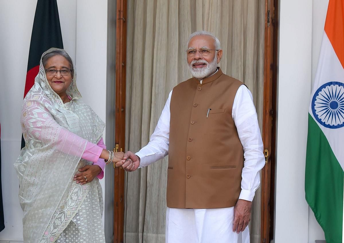 Prime Minister Narendra Modi shakes hands with his Bangladeshi counterpart Sheikh Hasina at Hyderabad House in New Delhi on Saturday. PTI