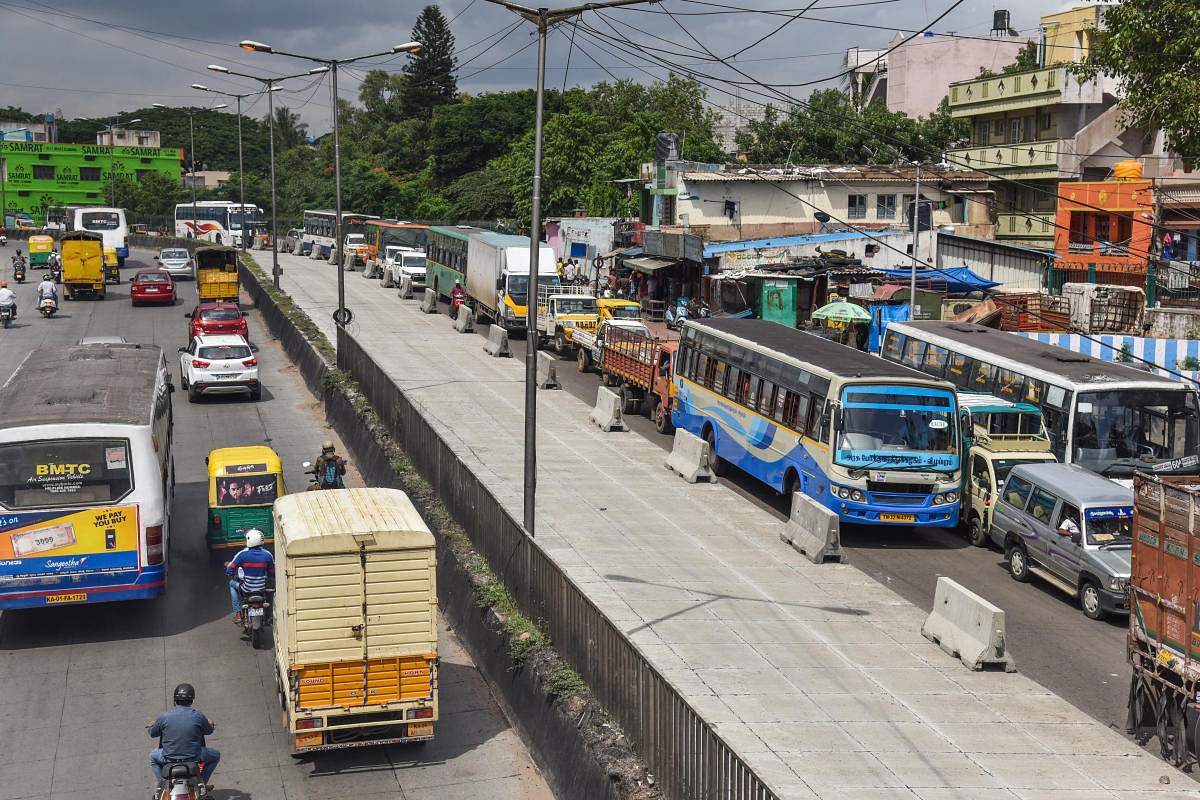 Due to white topping work, traffic is affected near tool gate, Mysuru road in Bengaluru on Monday. Photo by S K Dinesh