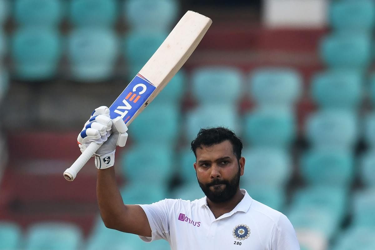 Indian cricketer Rohit Sharma raises his bat after scoring 100 runs during the fourth day's play of the first Test match between India and South Africa at the Dr. Y.S. Rajasekhara Reddy ACA-VDCA Cricket Stadium in Visakhapatnam on October 5, 2019. (AFP)