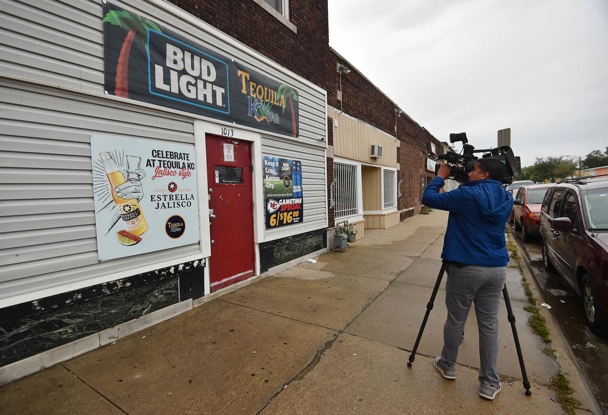 A local news videographer records footage of the entrance to Tequila KC bar were 9 people were shot and four killed on October 06, 2019 in Kansas City, Kansas. ( Ed Zurga/Getty Images/AFP)