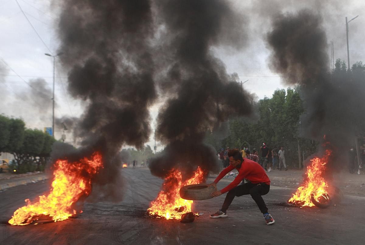 Baghdad: Anti-government protesters set fires and close a street during a demonstration in Baghdad, Iraq, Sunday, Oct. 6, 2019. The protests began with demands for jobs and an end to corruption, and now include calls for justice for those killed in the pr