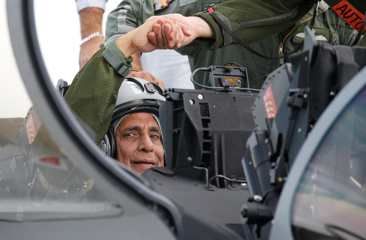 Defence Minister Rajnath Singh sits in the first Indian Air Force Rafale fighter jet on the tarmac before its take-off at the factory of French aircraft manufacturer Dassault Aviation in Merignac near Bordeaux, France. Reuters