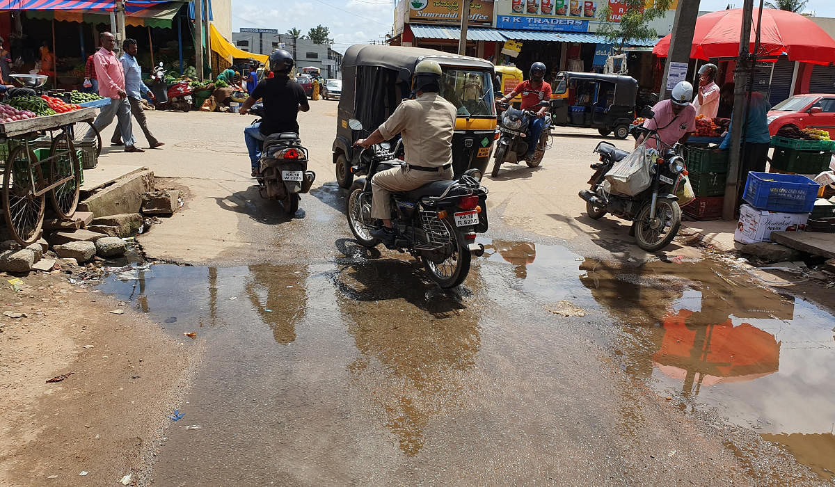 Dirty water from a drain overflows on the Market Road.