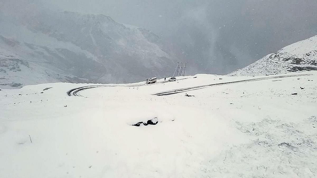 Vehicles stranded on Rohtang Pass after a fresh snowfall, in Kullu district on Oct. 7, 2019. (PTI Photo)
