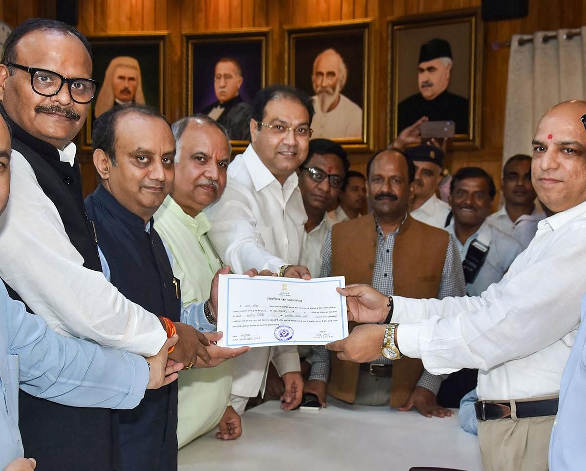 BJP National Spokesperson Sudhanshu Trivedi receives certificate after he was declared elected unopposed to the Rajya Sabha from Uttar Pradesh, in Lucknow on Wednesday. (PTI Photo) 