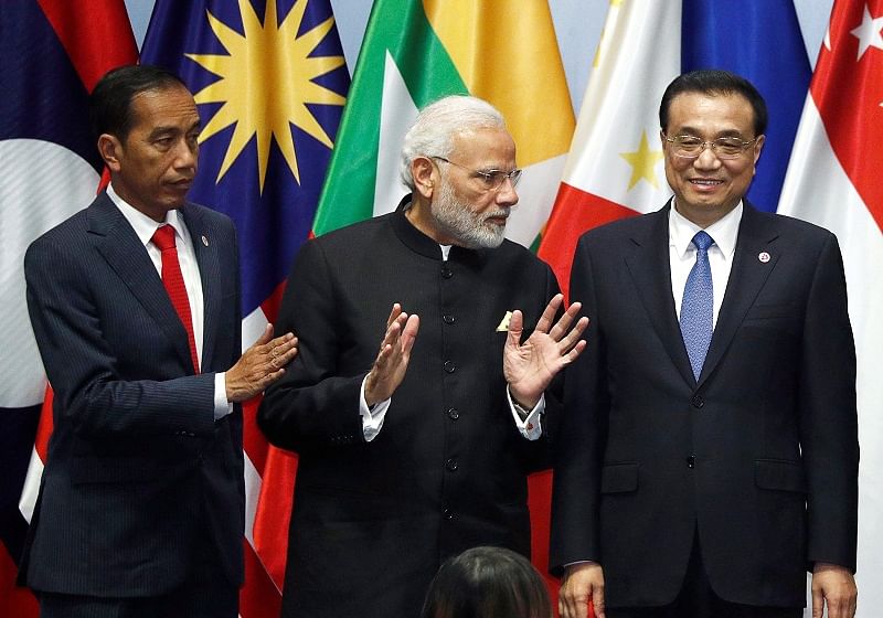 India's Prime Minister Narendra Modi speaks with China's Premier Li Keqiang next to Indonesia's President Joko Widodo as they gather for a group photo with ASEAN leaders at the Regional Comprehensive Economic Partnership (RCEP) meeting in Singapore. (Reuters Photo)