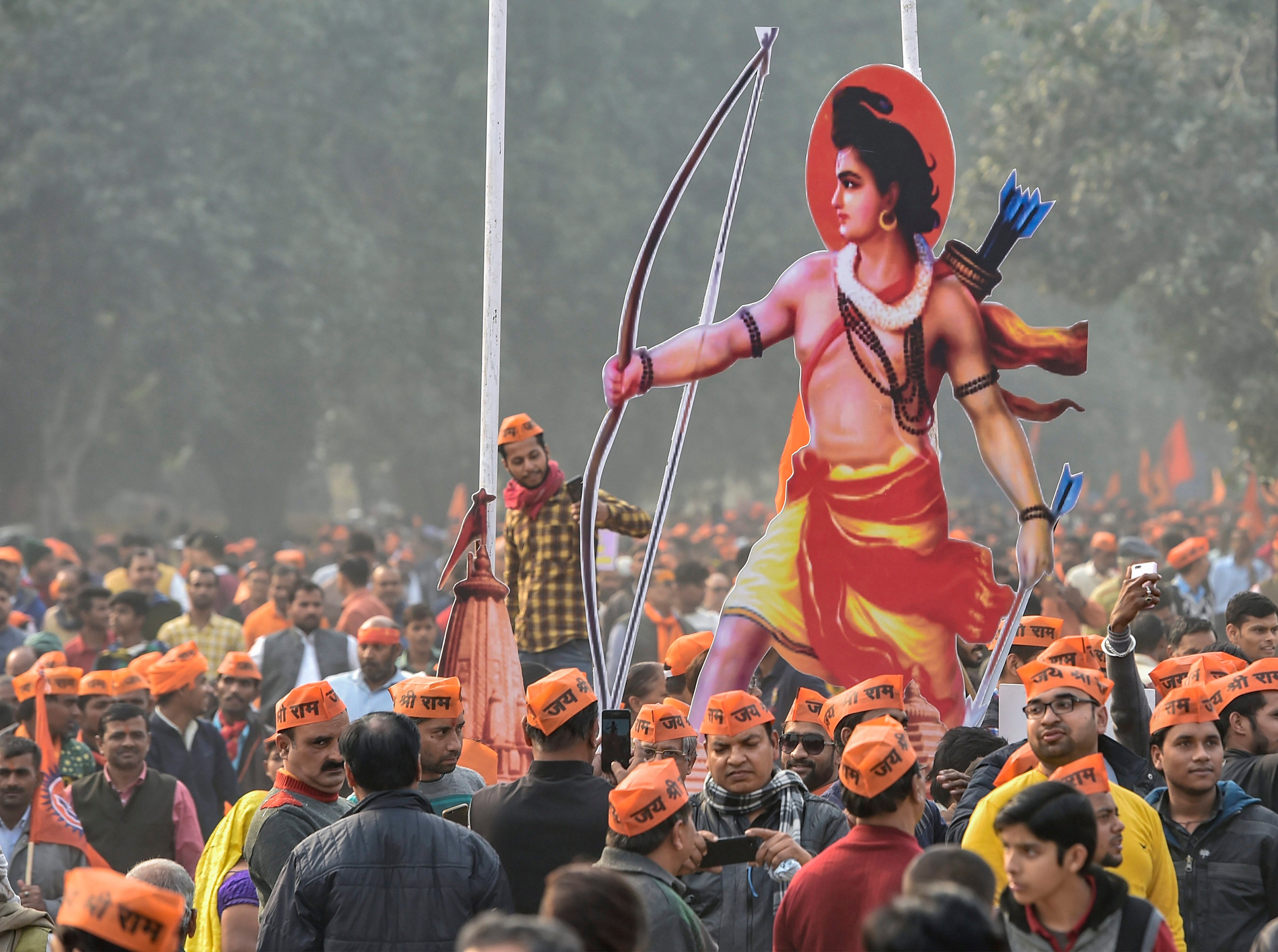 Vishwa Hindu Parishad’s (VHP) supporters carry a cutout of Lord Ram during ‘Dharma Sabha’, in which thousands of people gathered at Ramlila Maidan to press for the construction of Ram Temple in Ayodhya. (PTI Photo)
