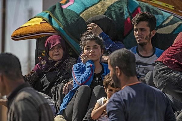Syrian Arab and Kurdish civilians arrive to Hassakeh city after fleeing following Turkish bombardment on Syria's northeastern towns along the Turkish border on October 10, 2019. (AFP photo)