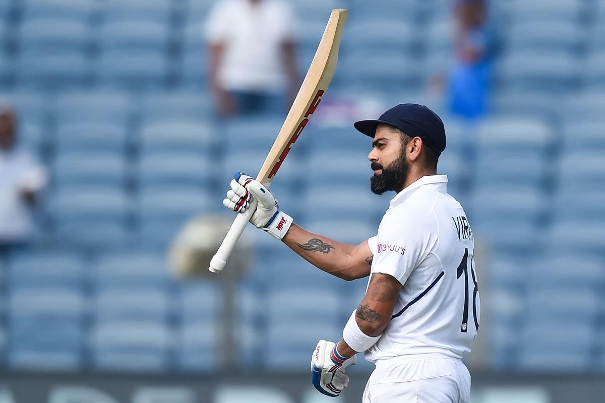 India's cricket team captain Virat Kohli celebrates after scoring a double century (200 runs) during the second day of the second Test cricket match between India and South Africa at Maharashtra Cricket Association Stadium in Pune on October 11, 2019. (Photo by Punit PARANJPE / AFP) 