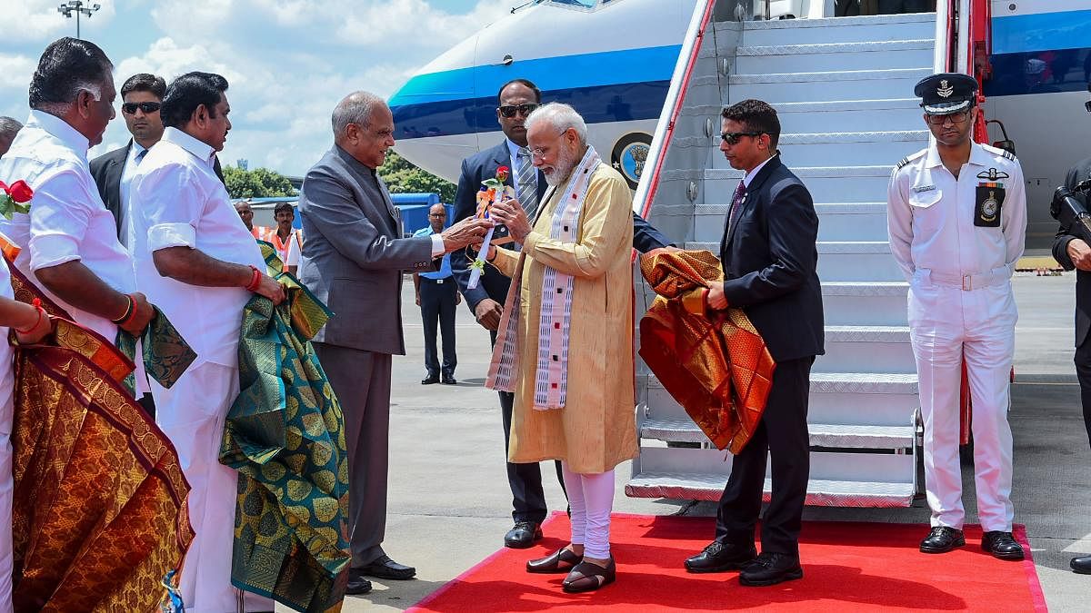 In this handout photograph taken and released by Indian Ministry of External Affairs (MEA) on October 11, 2019, India's Primer Minister Narendra Modi (C-R) arrives in Chennai, ahead of a summit with his Chinese counterpart President Xi Jinping to be held