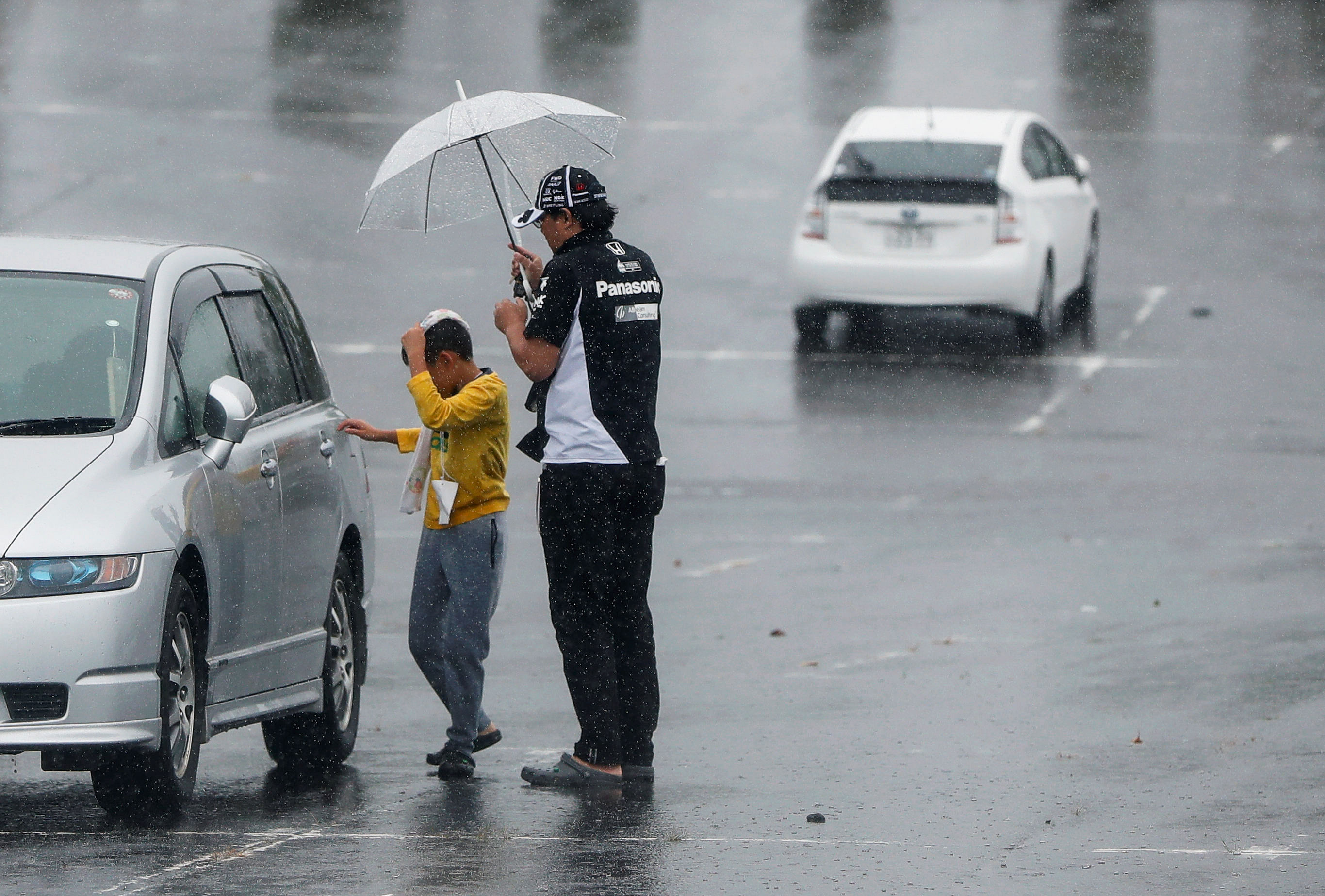 A family member of a Formula One fan gets into a car at a makeshift evacuation center for spectators of Formula One Japanese Grand Prix at Suzuka Circuit in Suzuka, central Japan. (Reuters Photo)