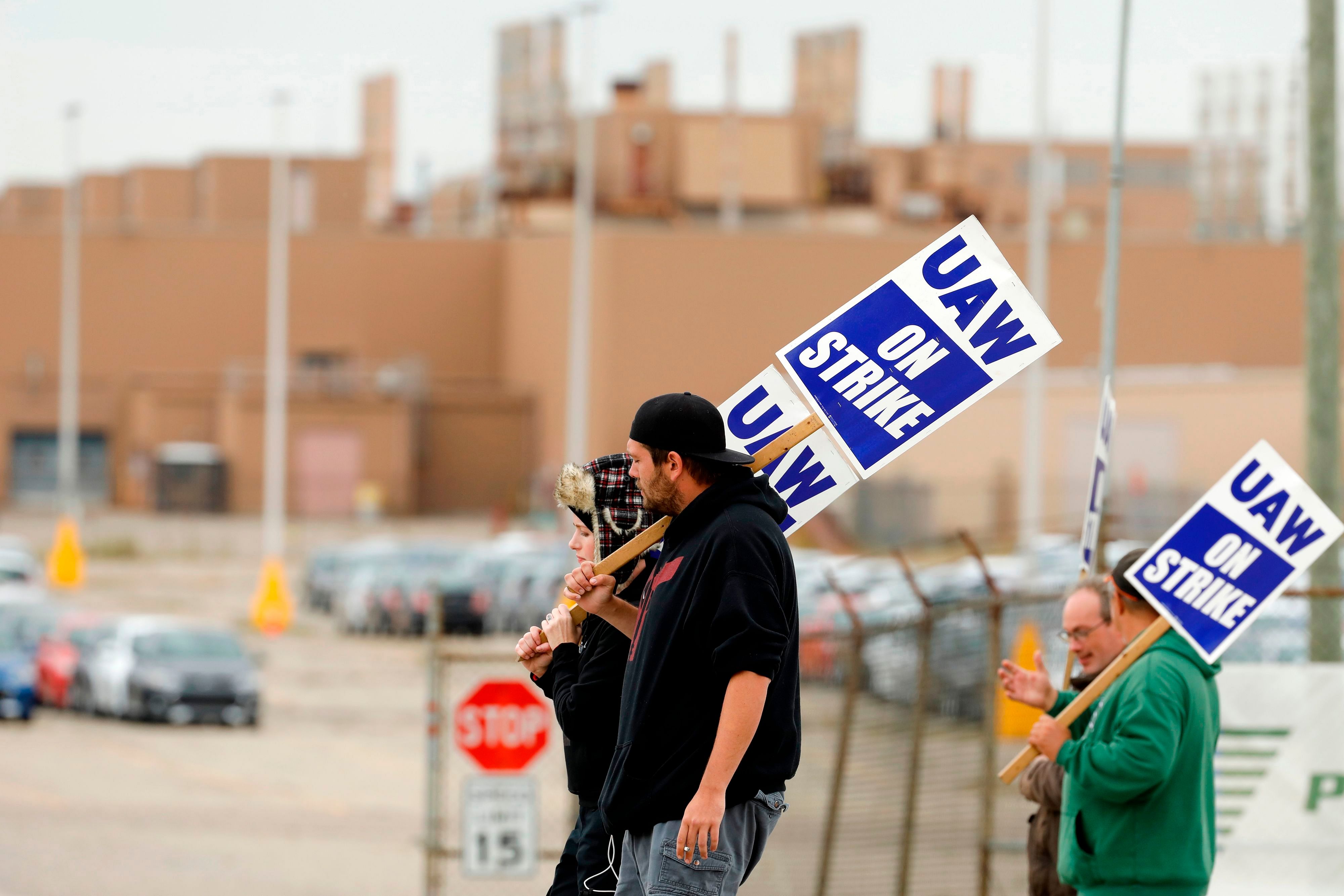 Amy and Matthew Harper walk the picket line outside General Motors (GM) Orion Assembly. (AFP Photo)