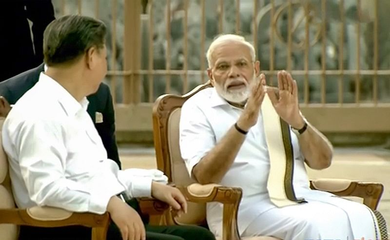 Prime Minister Narendra Modi speaks with Chinese President Xi Jinping, in Mamallapuram. (PTI Photo)