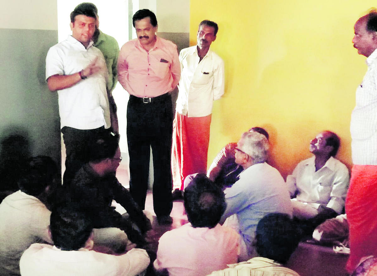 Belthangady MLA Harish Poonja addresses parents staging a dharna at the daycare centre for endosulfan victims in Kokkada in Beltangady taluk on Saturday.