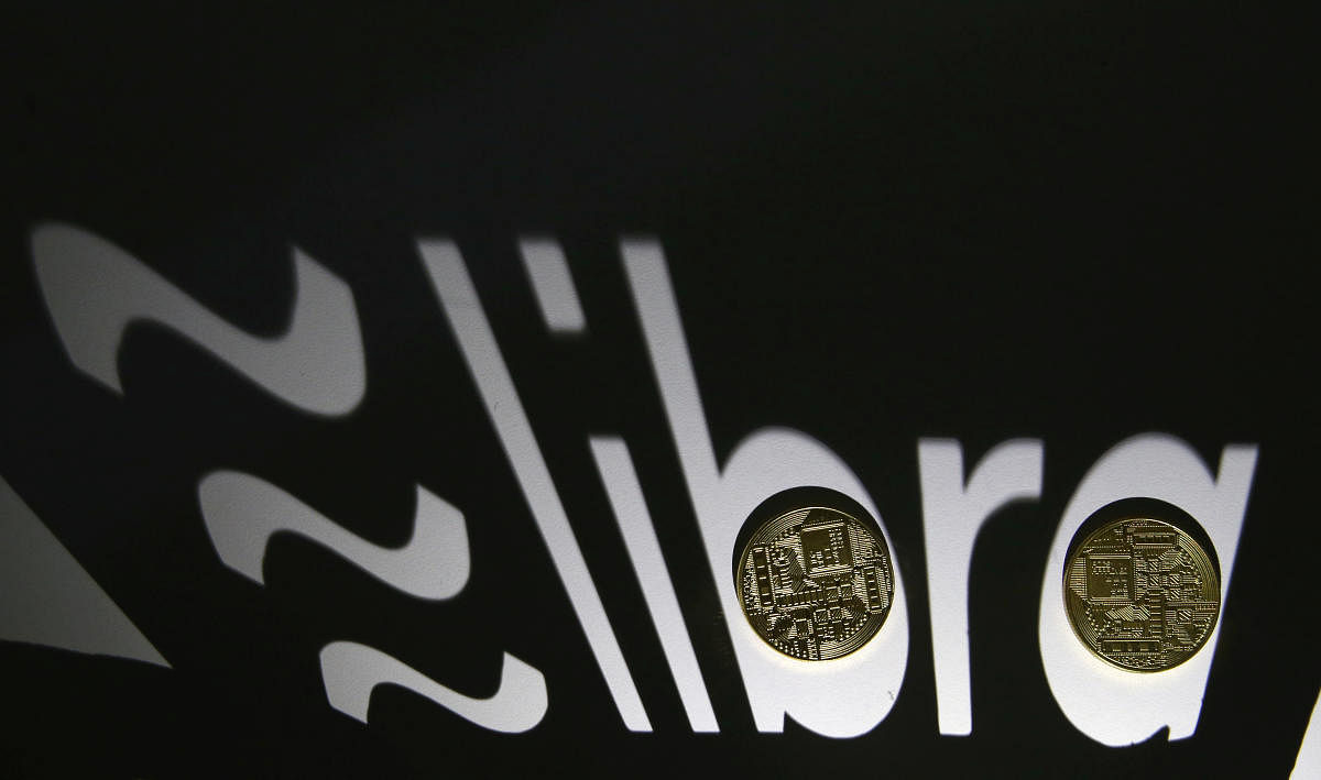 Shadow of a 3D-printed Facebook Libra cryptocurrency logo is seen near cryptocurrency representation in this illustration taken, September 13, 2019. Photo/Reuters