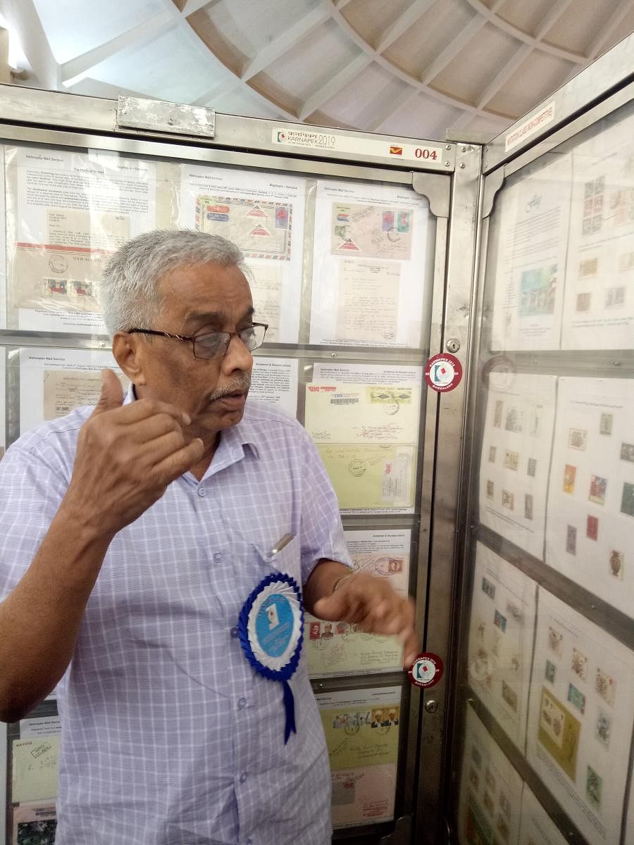 M K Krishnayya explains stamps on the history of flags at Karnapex 2019, at TMA Pai Convention Hall in Mangaluru.