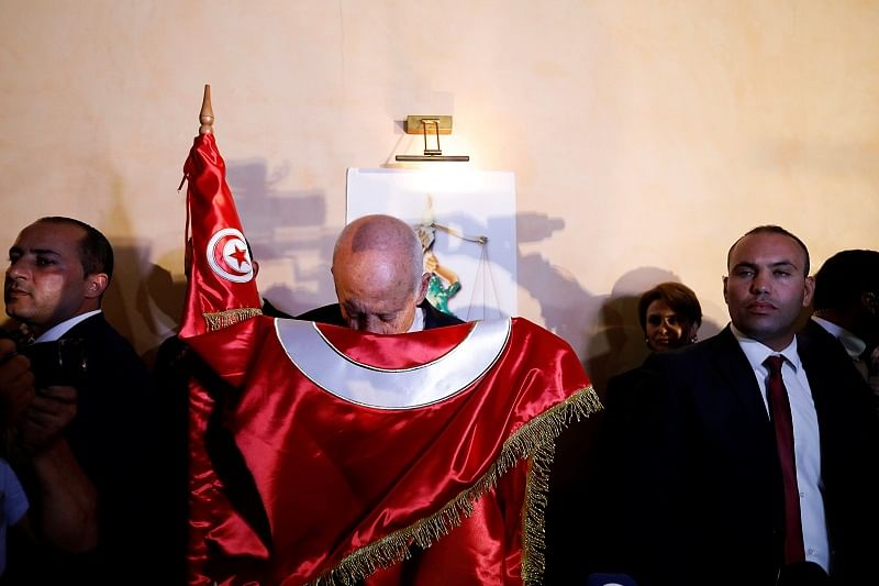 Tunisian presidential candidate Kais Saied reacts after exit poll results were announced in a second round runoff of the presidential election in Tunis, Tunisia. (Reuters Photo)