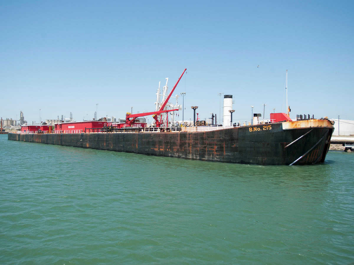 FILE PHOTO: A seagoing barge is loaded with crude oil at a dock at the Port of Corpus Christi. The oil prices have already seen a rise after missile strikes on iranian tanker in Saudi arabia last week. REUTERS/Darren Abate/File Photo