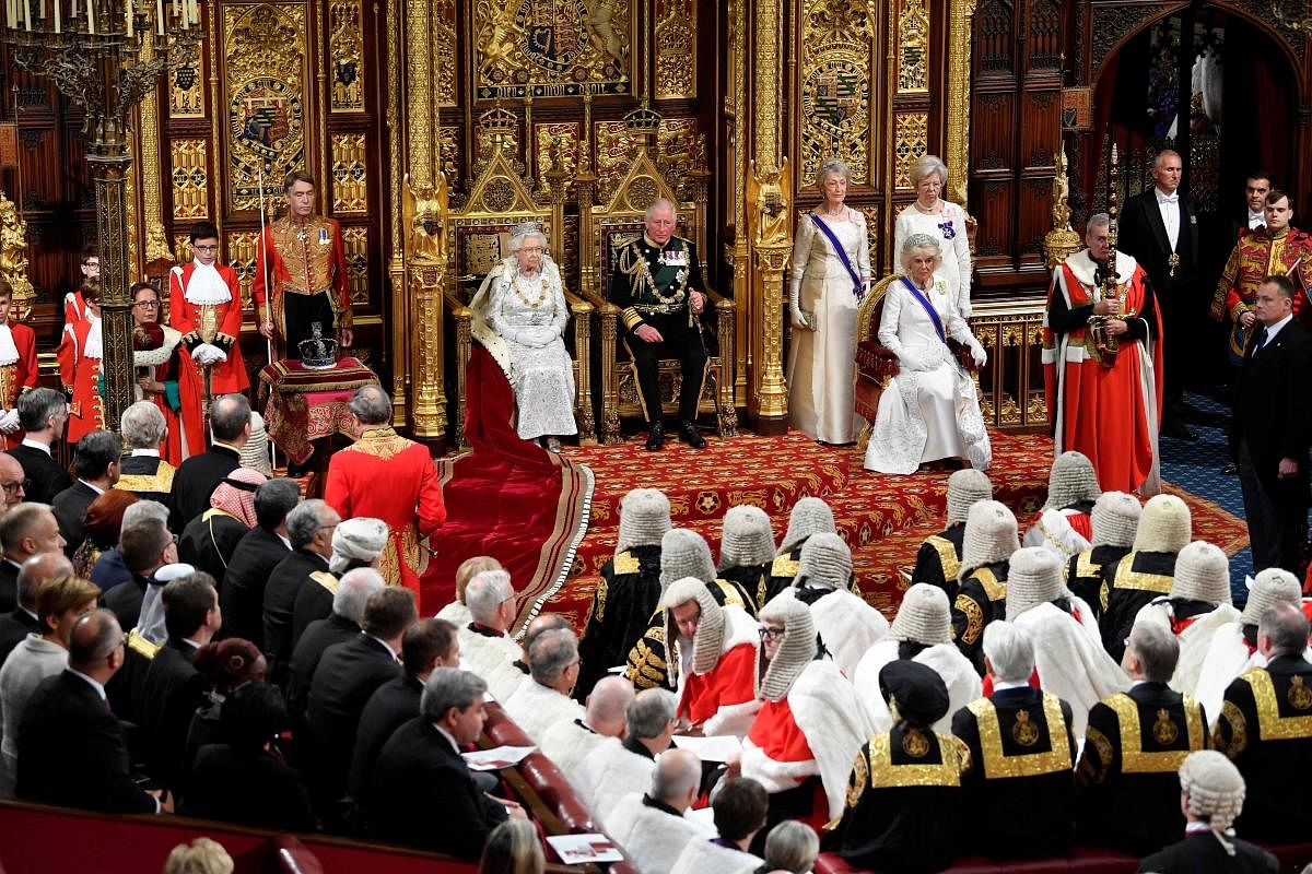 Britain's Queen Elizabeth II (centre left) sits with Britain's Prince Charles, Prince of Wales on the Sovereign's throne in the House of Lords ahead of delivering the Queen's Speech at the State Opening of Parliament in the Houses of Parliament in London on October 14, 2019. (AFP)