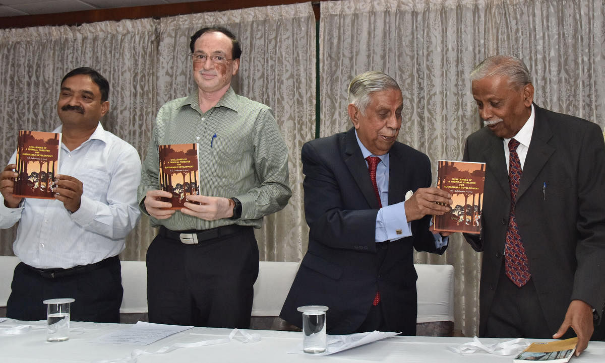 Former Chief Justice of India M.N. Venkatachaliah release a book " Challenges of a tropical forester for sustainable development" by IFS (Rtd), A C Lakshmana (Extreme right), during the book release program at Aranya Bhavan in Bengaluru on Monday, 14 Octo