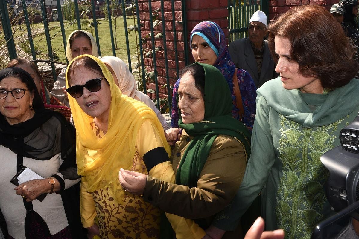 Suraya Mattoo (2nd L), sister of Kashmiri political leader Farooq Abdullah and aunt of former Jammu and Kashmir chief minister Omar Abdullah who both remain under house arrest, and Farooq's daughter Safiya (R) take part in a protest held by the civil society group Women in Kashmir against human rights violations in the region and the removal of the special status of Kashmir, in Srinagar on October 15, 2019. (Photo by HABIB NAQASH / AFP)