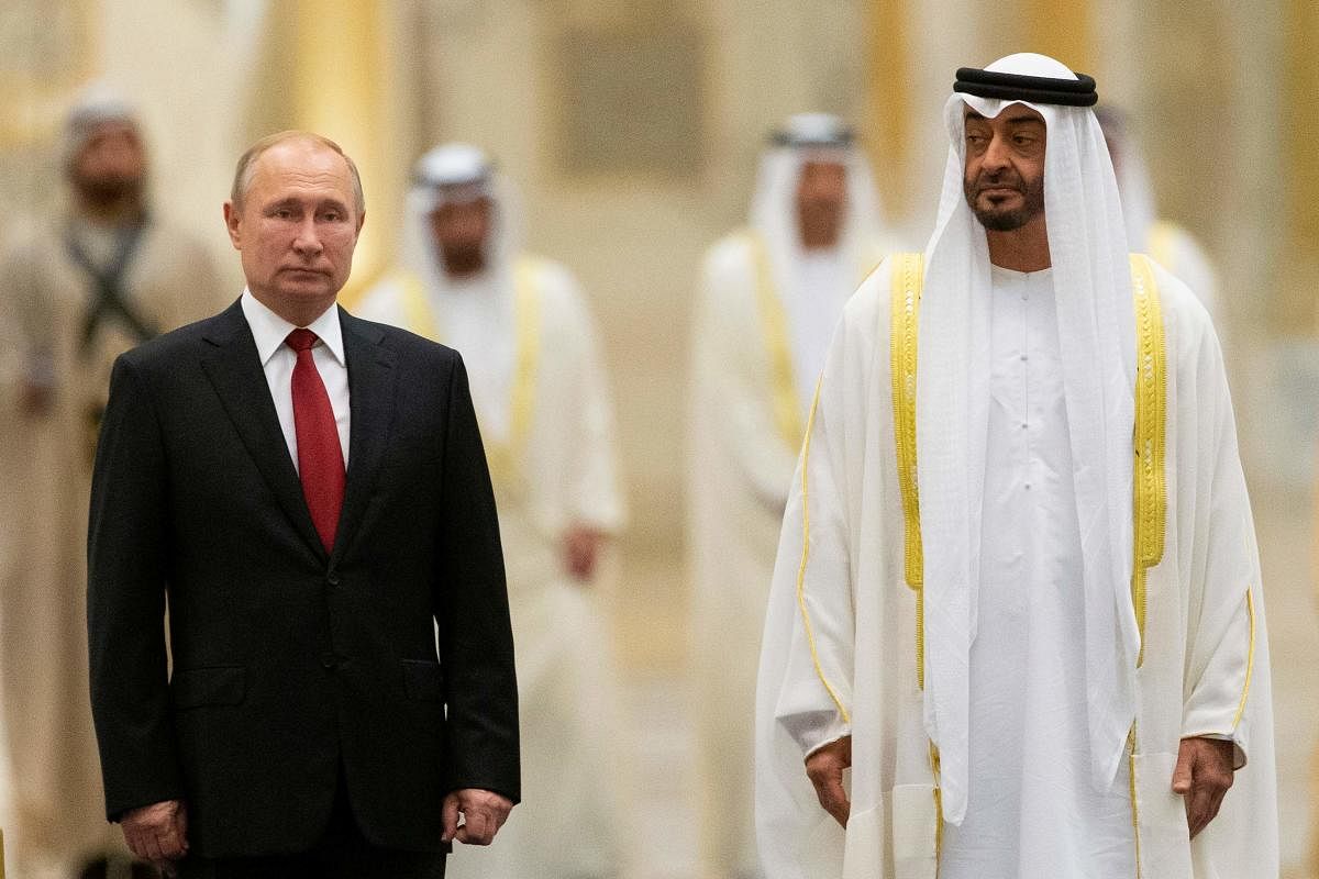 Russian President Vladimir Putin and Abu Dhabi Crown Prince Mohammed bin Zayed al-Nahyan attend the official welcome ceremony in Abu Dhabi, United Arab Emirates, on October 15, 2019. (Photo by Alexander Zemlianichenko / POOL / AFP)