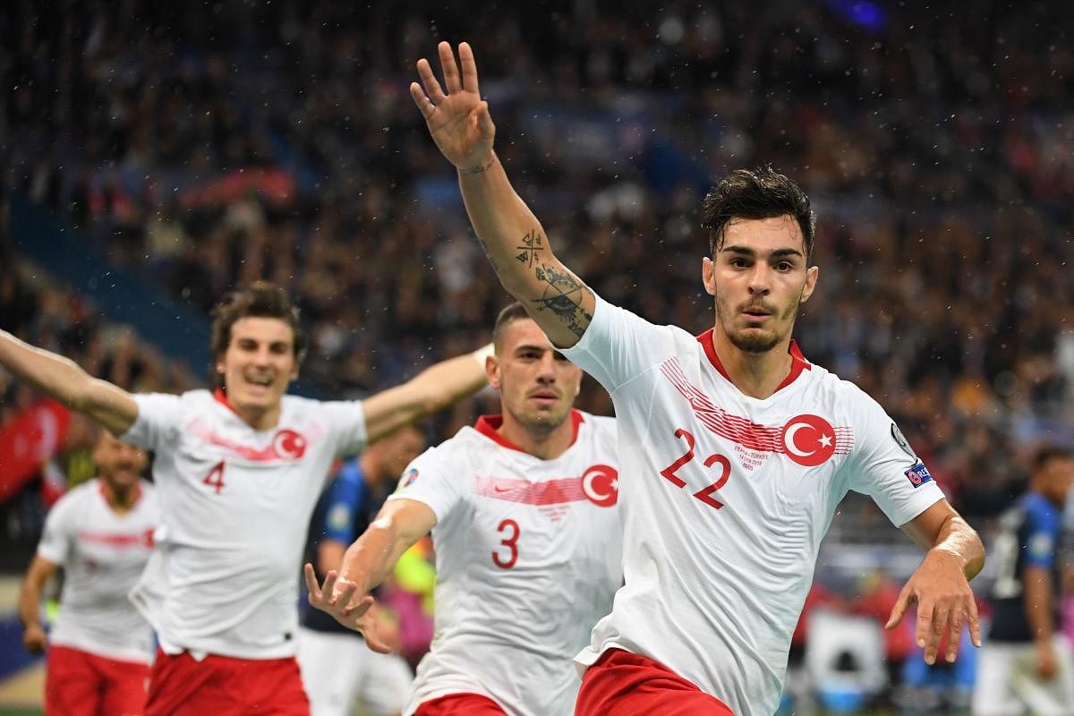 Turkey's defender Kaan Ayhan (R) celebrates after scoring the equalizer during the Euro 2020 Group H qualification football match between France and Turkey at the Stade de France in Saint-Denis, outside Paris on October 14, 2019. (AFP)