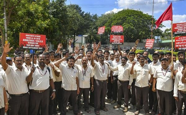 Members of All India HAL trade unions raise slogans as they stage a protest during their strike to demand for fair and early settlement of wage revision of employees, in Bengaluru. (PTI photo)