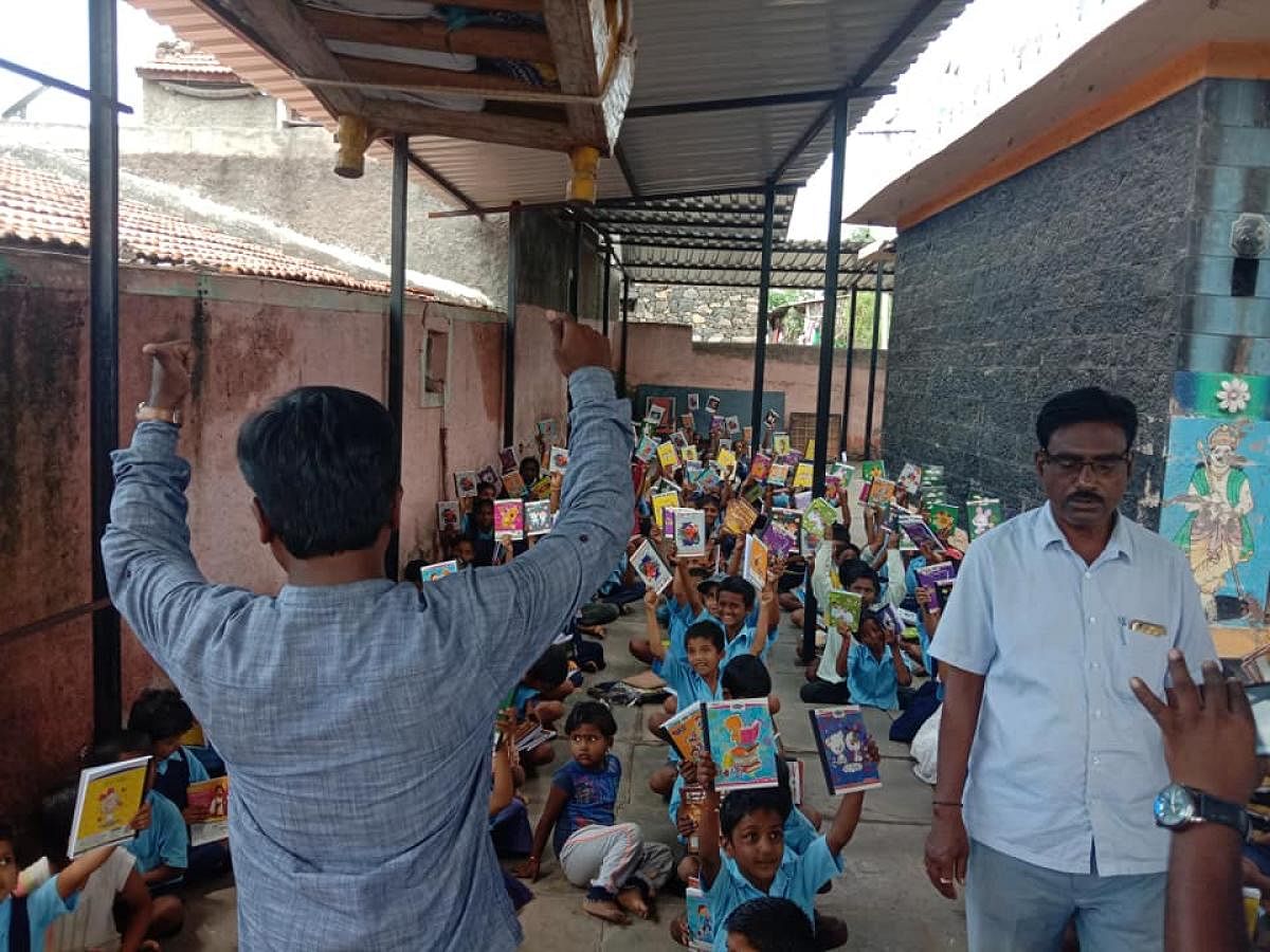 Classes are held at a temple, following damages to the classroms at the government higher primary school in Raibag taluk of Belagavi district. dh photo