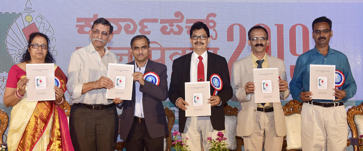 Mangalore University Vice Chancellor Prof P S Yadapadithaya (third from right) and others release the souvenir at Karnapex 2019, the state-level philately exhibition, organised at the Dr T M A Pai Convention Hall on Tuesday.
