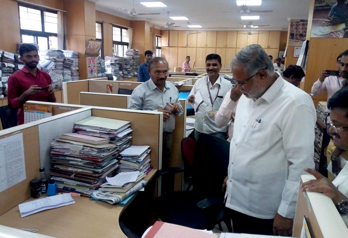 Primary and Secondary Education Minister S Suresh Kumar takes stock of pending files at the department at the education secretariat office in Bengaluru on Wednesday.