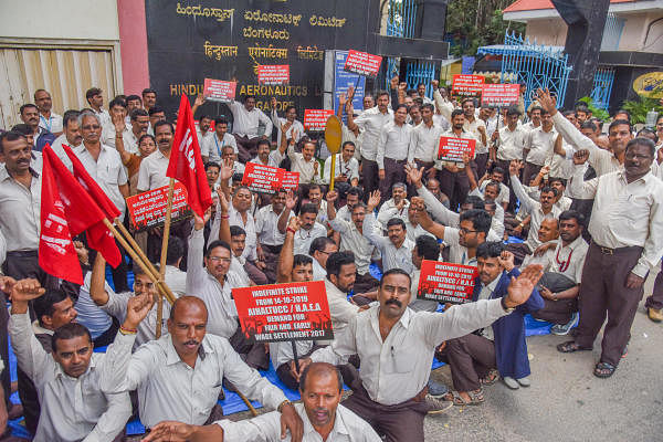 Hindustan Aeronautics Limited (HAL) Employees staging indefinite strike, demanding for fair and early wage revision, under the banner of All India HAL Trade Unions Co ordination committee in front of HAL, Old Airport Road, Bengaluru on Monday. (DH Photo/S K Dinesh)