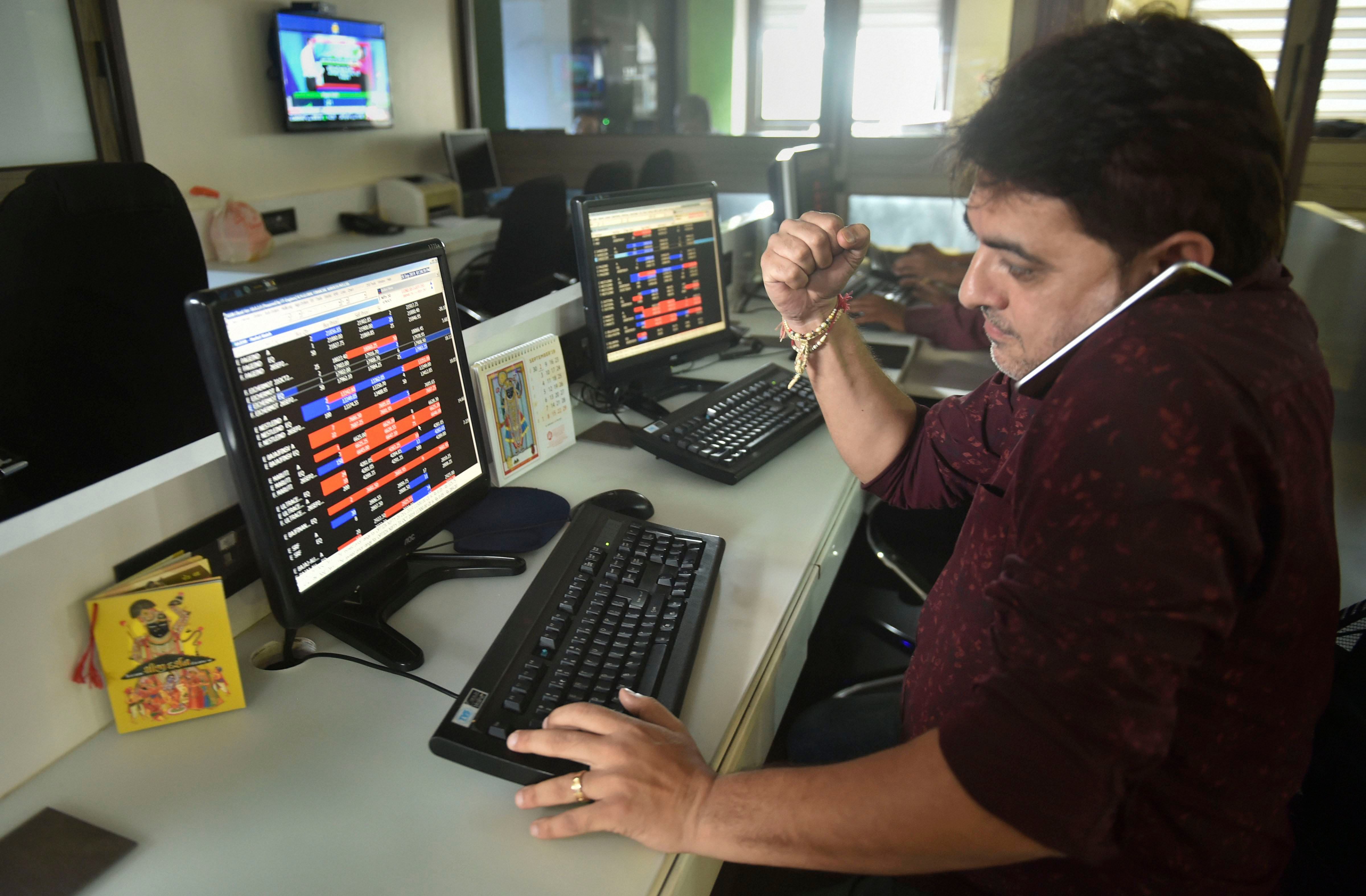 Stock broker react as they watch the stock prices on a computer screen, at BSE building in Mumbai. (PTI Photo)