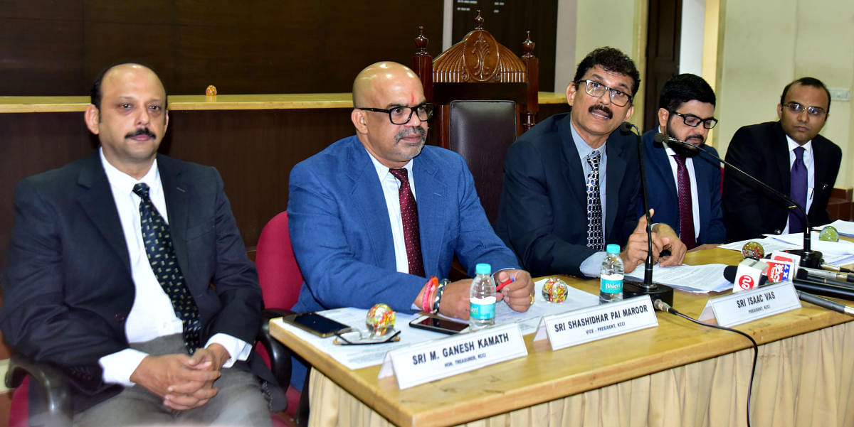 Isaac Vas (centre), who took charge as president of Kanara Chamber of Commerce and Industry, addresses reporters at KCCI hall, Mangaluru, on Thursday.