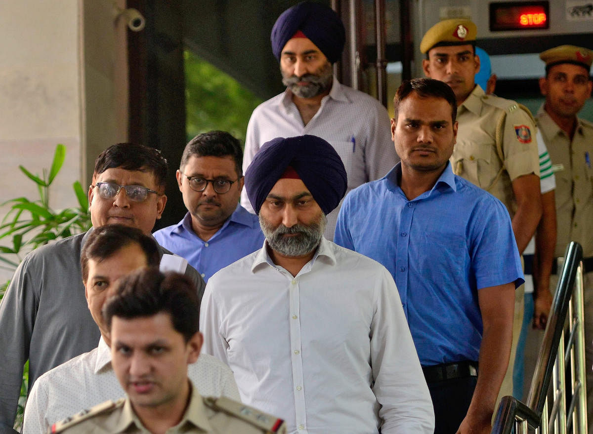 Police escort Malvinder Singh and his brother Shivinder Singh, former directors of Ranbaxy Laboratories, inside a court premises in New Delhi, India, October 11, 2019. REUTERS Photo