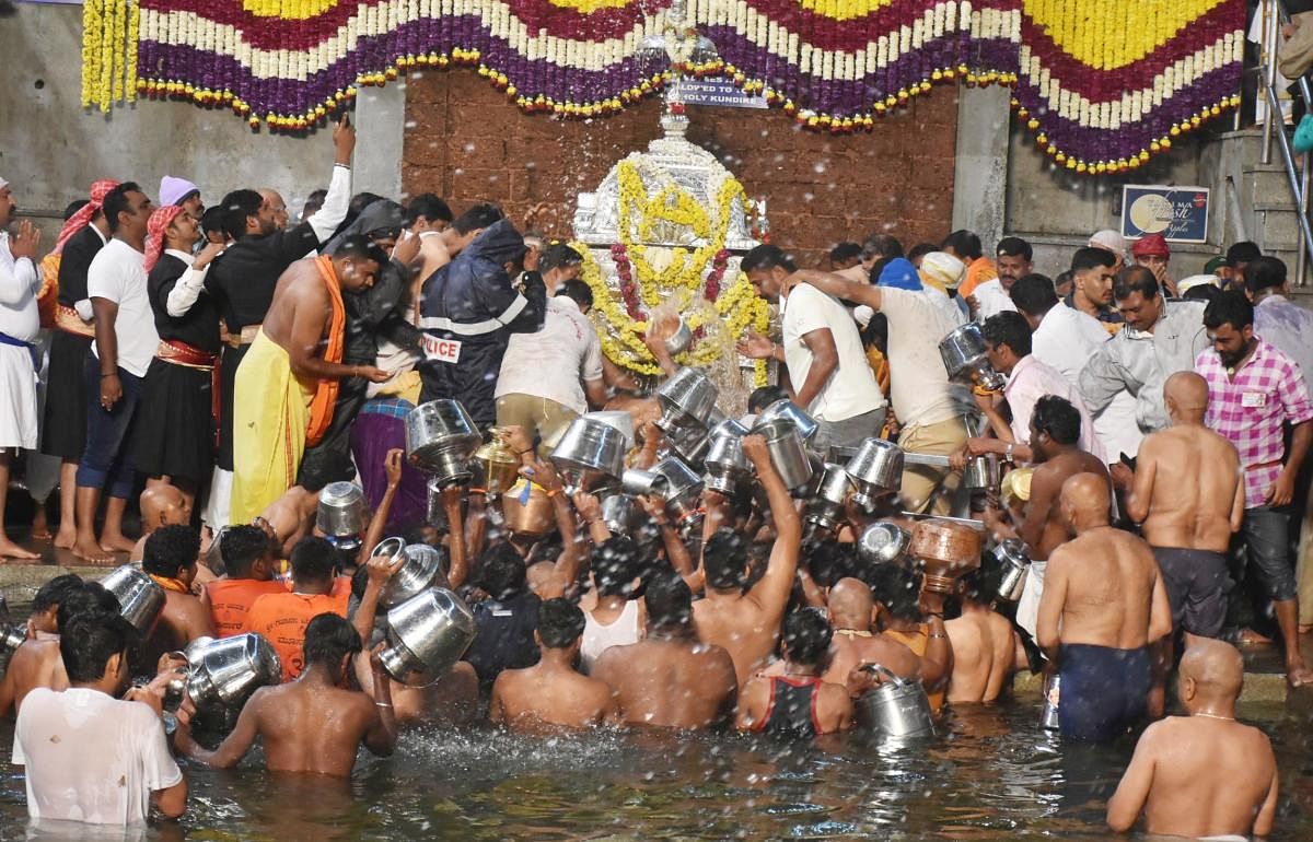 Devotees throng Talacauvery to collect water from Theerthakundike, after the Theerthodbhava celebrations.