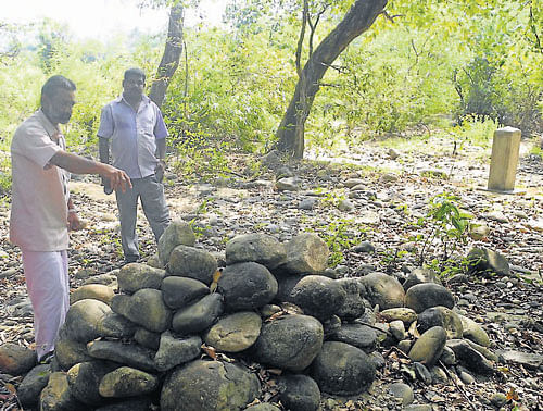 A delegation from the Ayyan Kunnu gram panchayat visits the alleged encroached land at Makootta along Kodagu-Kannur border. The new installed concrete pole, as alleged by Kerala can also be seen. (Inset) The survey stone that marks the border between Karnataka and Kerala in a re-installed condition (as alleged by Kerala). DH PHOTO