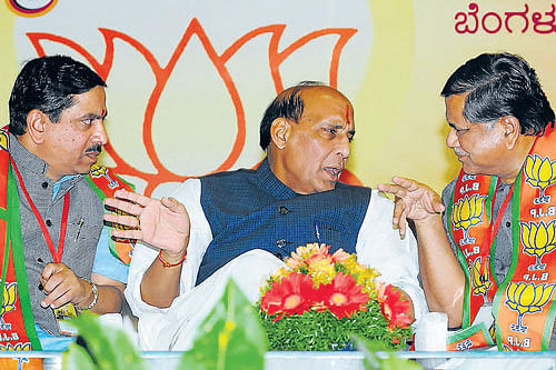 BJP State president Pralhad Joshi, National president Rajnath Singh and former chief minister Jagadish Shettar at the special executive committee meeting in Bangalore on Friday. dh photo