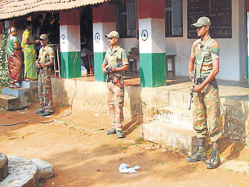 ANF personnel provide security in Vanachalu School in Madikeri during Lok Sabha election polling, on Thursday. The polling booth was considered as highly sensitive. DH Photo