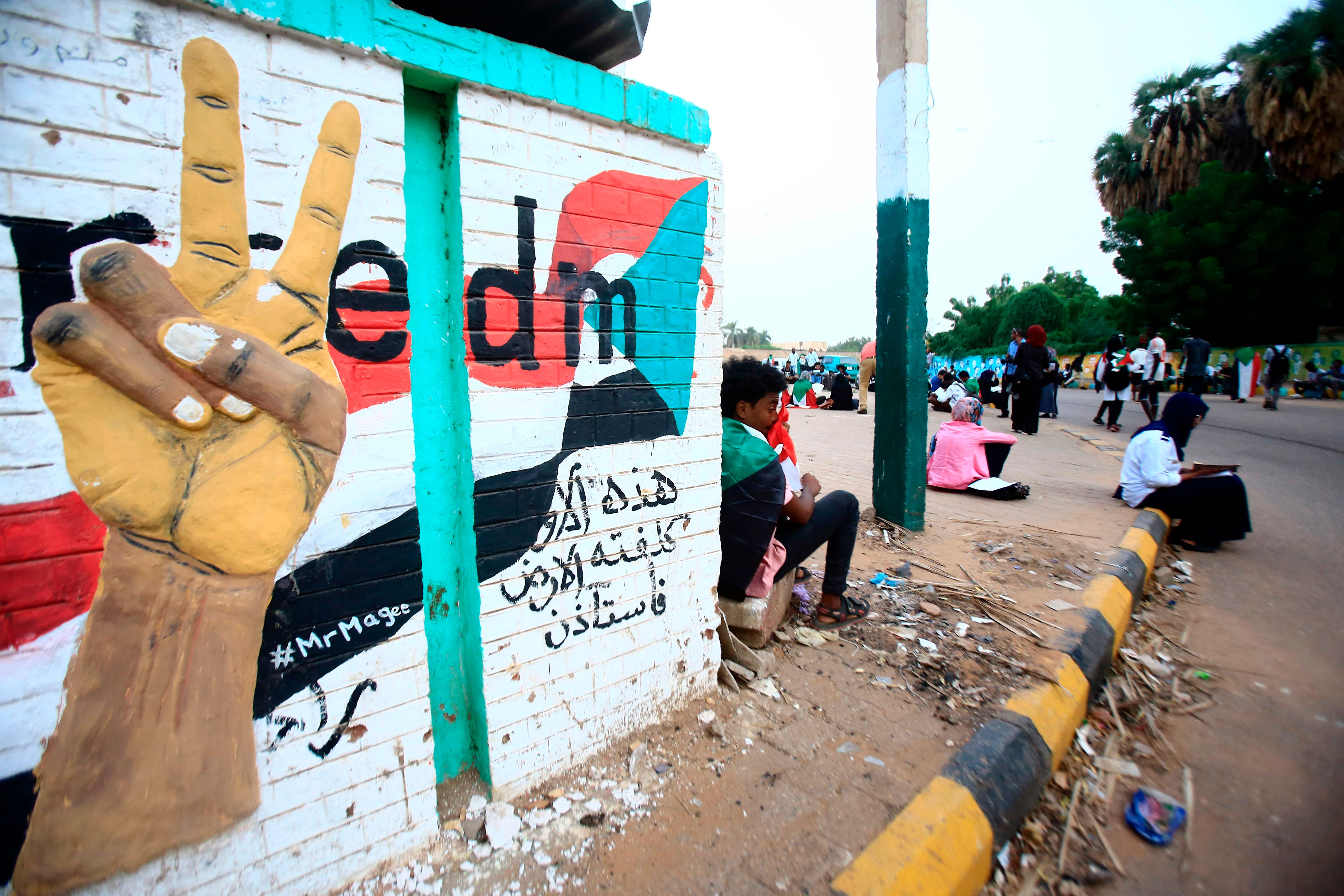 udanese demonstrators gathering for a vigil outside the entrance of the former Nile Street sit-in in the capital Khartoum. (AFP Photo)