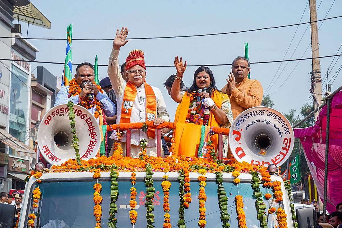 Haryana Chief Minister Manohar Lal Khattar waves at his supporters during a roadshow in support of BJP candidate Kavita Jain, ahead of Haryana Assembly polls, in Sonipat, Saturday, Oct. 19, 2019. (PTI Photo)