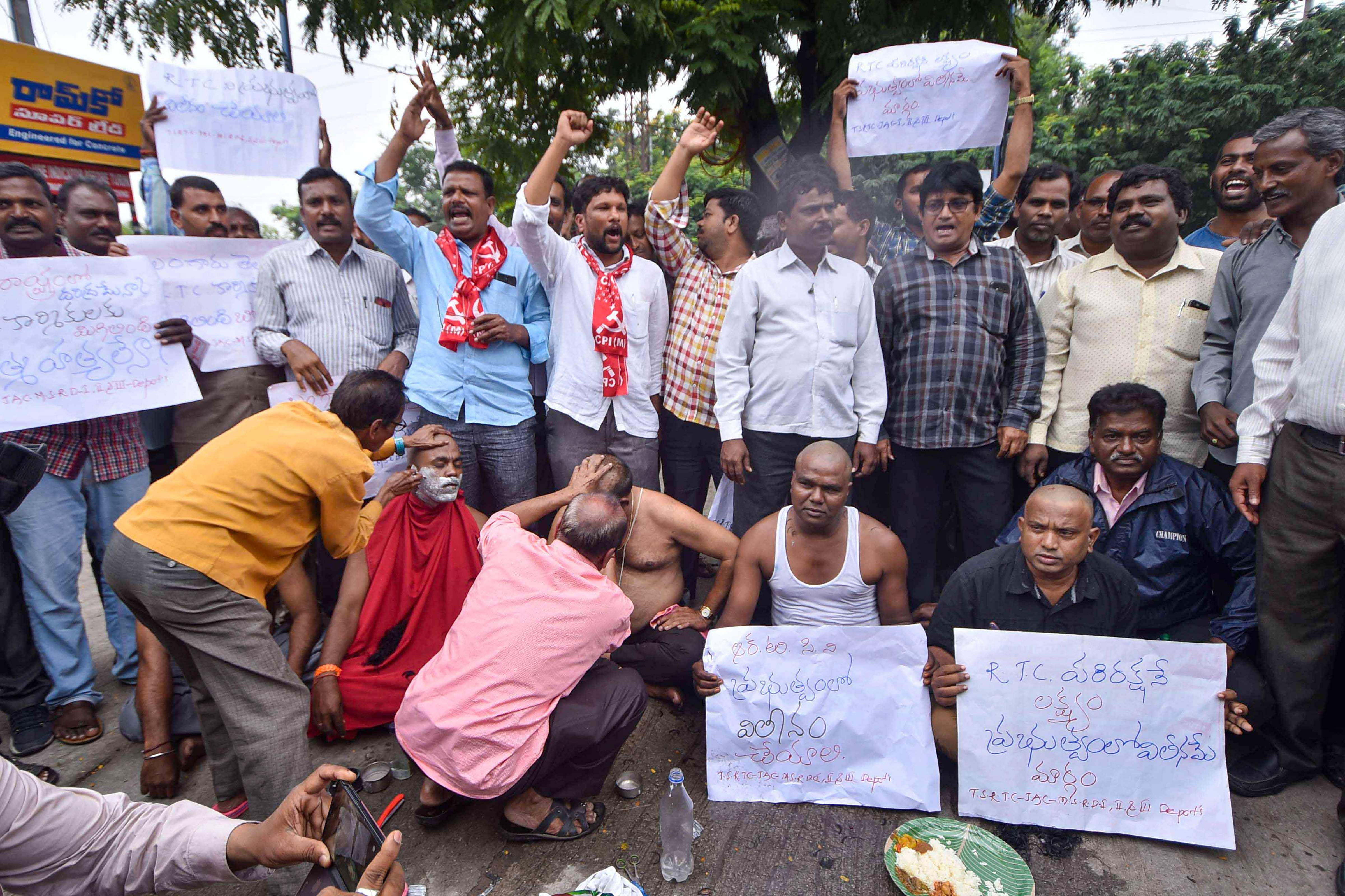 Agitating Telangana State Road Transport Corporation (TSRTC) get their heads tonsured during their ongoing strike, in Hyderabad. (PTI Photo)